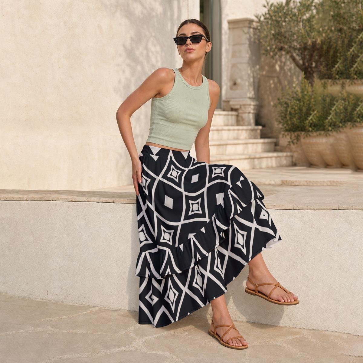 Woman wearing the Black & White Ikat Print Tiered Ruffle Maxi Skirt by Creamy Cougar