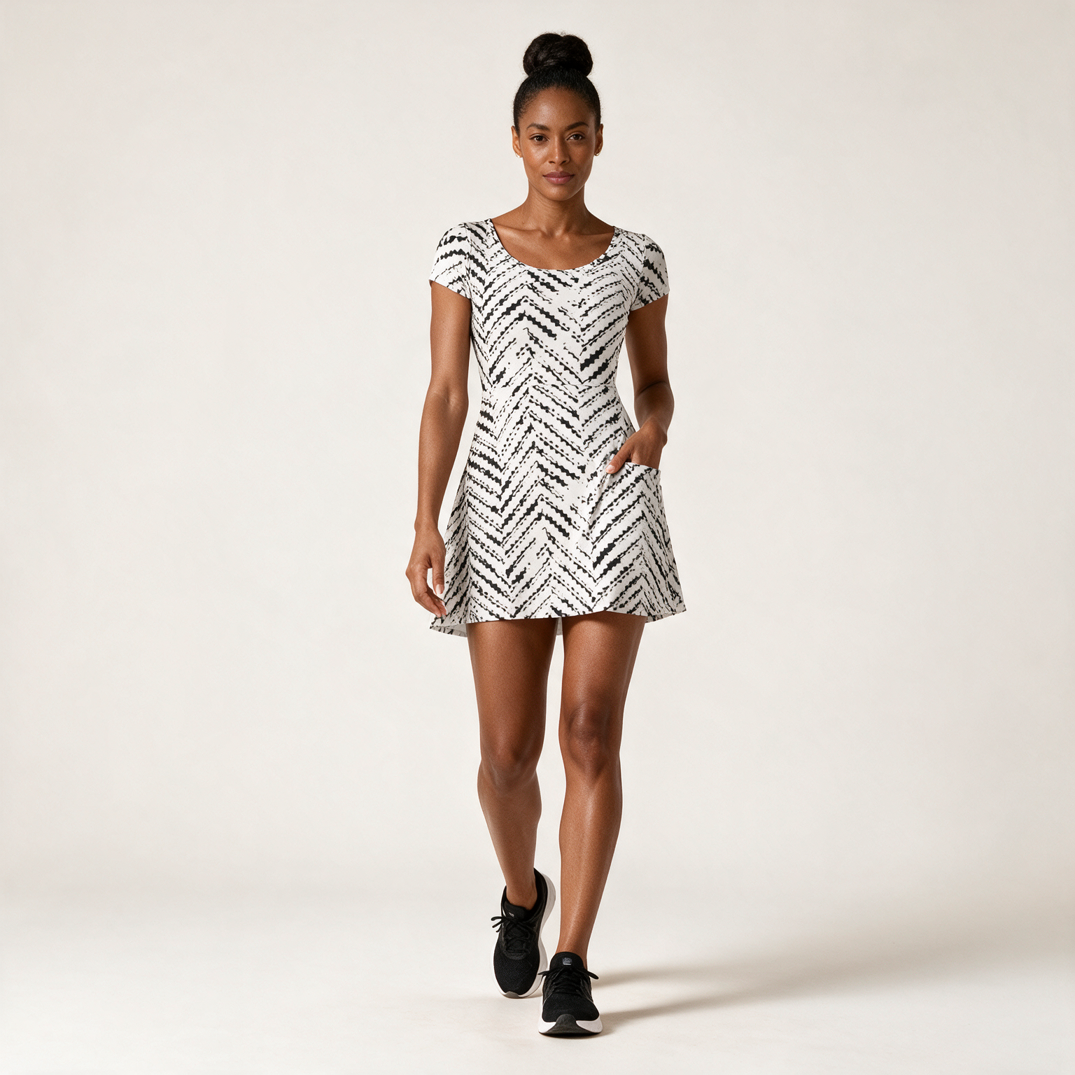 Woman wearing the Zebra Chevron Athletic Dress with Built-In Shorts by Creamy Cougar
